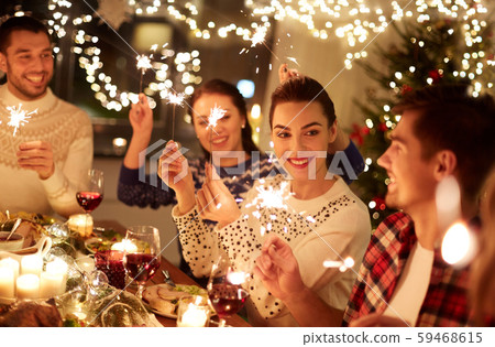 happy friends celebrating christmas at home feast 59468615