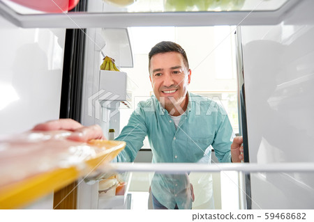 man taking food package from fridge at kitchen 59468682