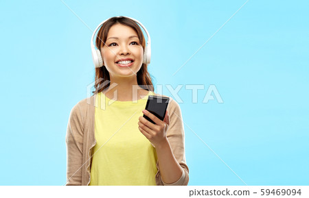 asian woman in headphones listening to music asian woman in headphones listening to music 59469094