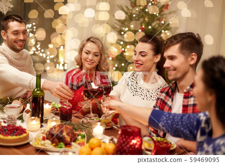 friends celebrating christmas and drinking wine friends celebrating christmas and drinking wine 59469095