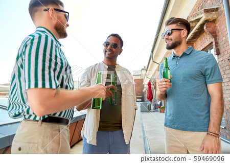 happy male friends drinking beer at rooftop party happy male friends drinking beer at rooftop party 59469096