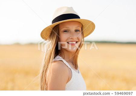 portrait of girl in straw hat on field in summer portrait of girl in straw hat on field in summer 59469097