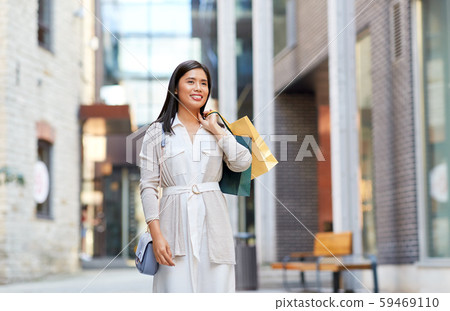 asian woman with shopping bags walking in city asian woman with shopping bags walking in city 59469110