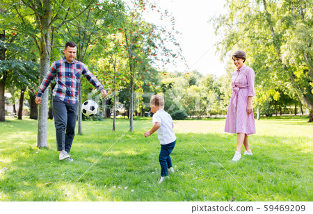 happy family playing soccer at summer park happy family playing soccer at summer park 59469209