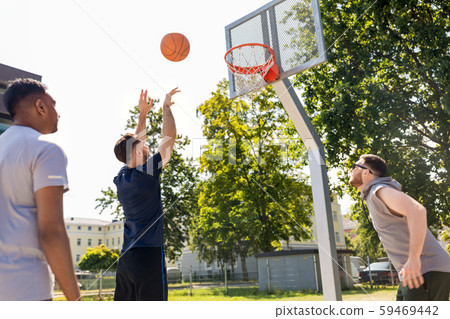 group of male friends playing street basketball 59469442
