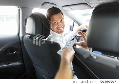 male car driver taking money from passenger 59469597