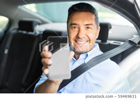 passenger or businessman showing smartphone in car passenger or businessman showing smartphone in car 59469631