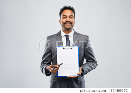indian businessman with contract on clipboard 59469672