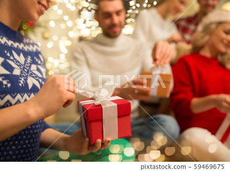 close up of friends opening christmas gifts close up of friends opening christmas gifts 59469675