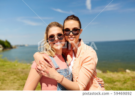 teenage girls or best friends at seaside in summer teenage girls or best friends at seaside in summer 59469892