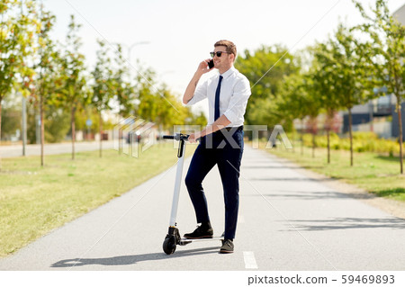 businessman with scooter calling on smartphone businessman with scooter calling on smartphone 59469893