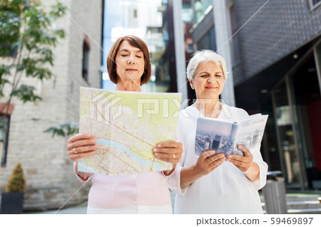 senior women with city guide and map on street senior women with city guide and map on street 59469897