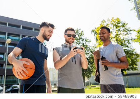 men with smartphone at basketball playground 59469908