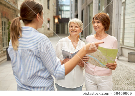 passerby showing direction to senior women in city passerby showing direction to senior women in city 59469909