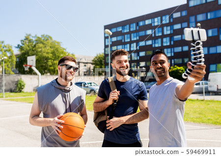 happy men taking selfie at basketball playground happy men taking selfie at basketball playground 59469911