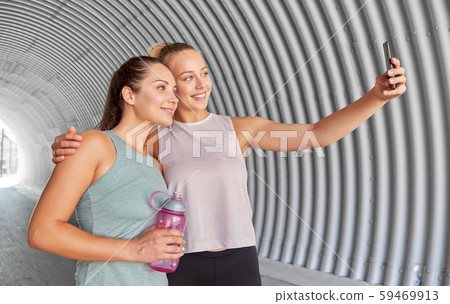sporty women taking selfie by smartphone outdoors sporty women taking selfie by smartphone outdoors 59469913