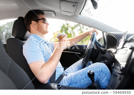 man or driver with takeaway coffee cup driving car man or driver with takeaway coffee cup driving car 59469930