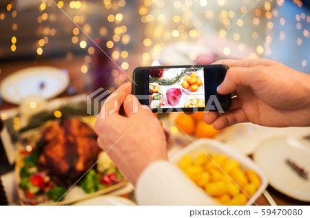 hands photographing food at christmas dinner hands photographing food at christmas dinner 59470080