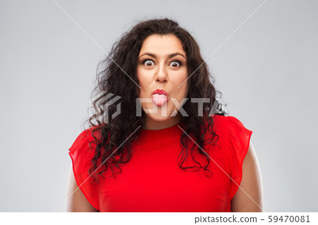 happy woman in red dress showing tongue happy woman in red dress showing tongue 59470081