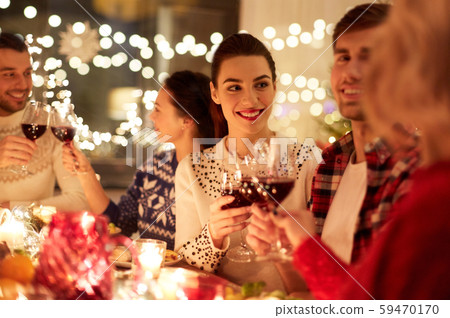 happy friends celebrating christmas at home feast happy friends celebrating christmas at home feast 59470170