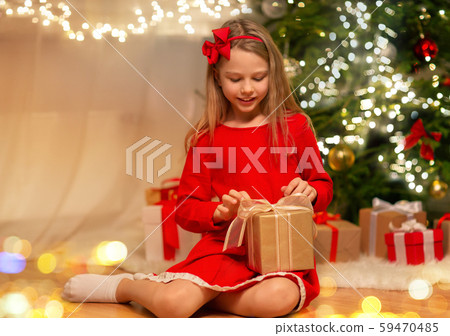 smiling girl with christmas gift at home 59470485