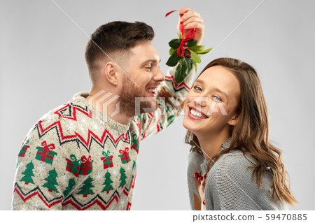 happy couple kissing under the mistletoe 59470885
