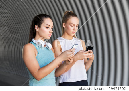 women or female friends with smartphones women or female friends with smartphones 59471202