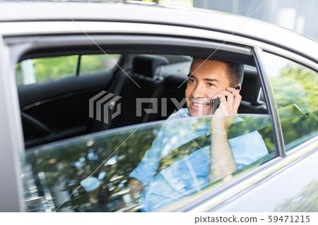 male passenger calling on smartphone in taxi car male passenger calling on smartphone in taxi car 59471215