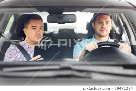 car driving school instructor and young driver car driving school instructor and young driver 59471254