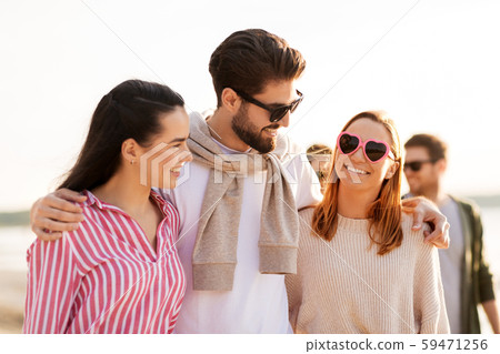 happy friends walking along summer beach happy friends walking along summer beach 59471256