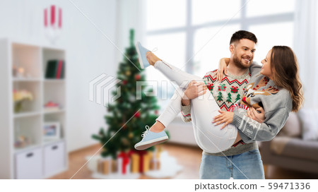 happy couple at christmas ugly sweater party 59471336
