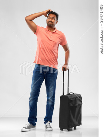puzzled indian man with travel bag shrugging 59471409