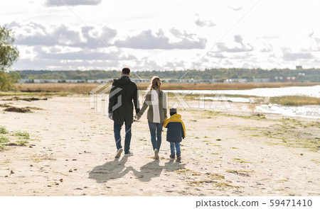 happy family walking along autumn beach happy family walking along autumn beach 59471410