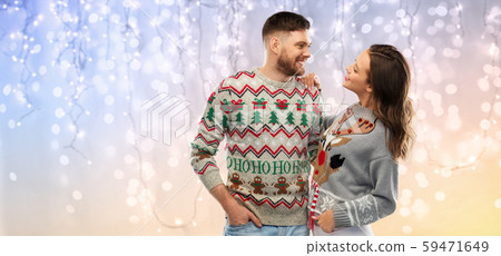 happy couple at christmas ugly sweater party 59471649