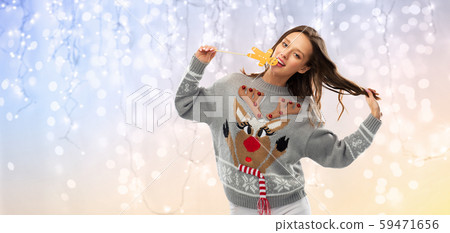 woman in christmas sweater with reindeer pattern 59471656