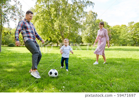 happy family playing soccer at summer park 59471697