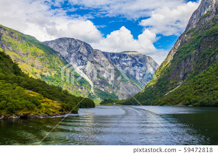 Scenic landscape View on the mountain peaks with green slopes and surface of water and feather 59472818