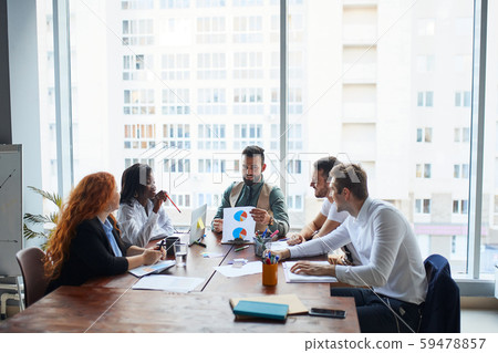 arabian man coach mentor teacher talking to workers interns in office 59478857