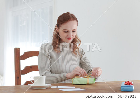 Foreign woman making a present by herself Foreign woman making a present by herself 59478925