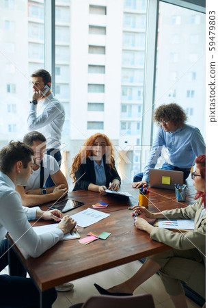 Young group of coworkers discussing in Conference Room with panoramic window Young group of coworkers discussing in Conference Room with panoramic window 59479803