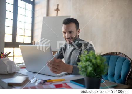 Handsome businessman working on laptop at the weekend Handsome businessman working on laptop at the weekend 59480633