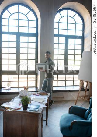 Experienced interior designer working in his modern office Experienced interior designer working in his modern office 59480667