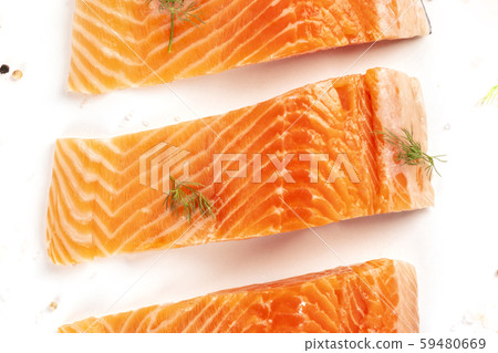 Salmon slices close-up, top shot with salt, pepper, and dill on a white background Salmon slices close-up, top shot with salt, pepper, and dill on a white background 59480669