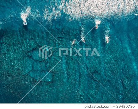 Aerial view with surfers and wave in crystal blue ocean. Top view Aerial view with surfers and wave in crystal blue ocean. Top view 59480750
