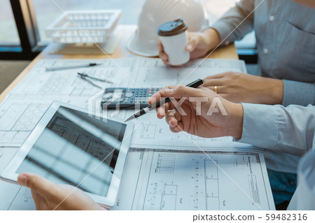 Two engineering working together and using digital 59482316