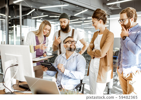 Manager with office workers in the office Manager with office workers in the office 59482365