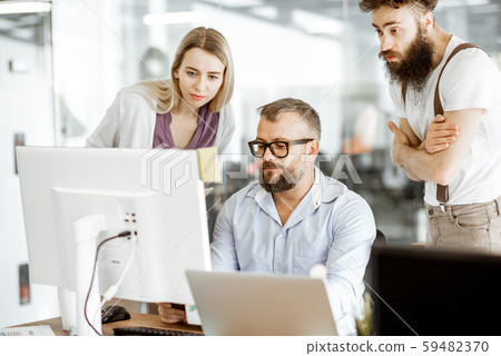 Manager with office workers in the office Manager with office workers in the office 59482370