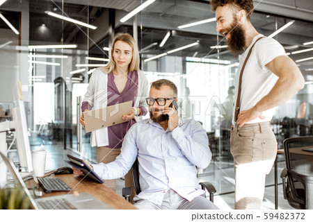 Manager with office workers in the office Manager with office workers in the office 59482372
