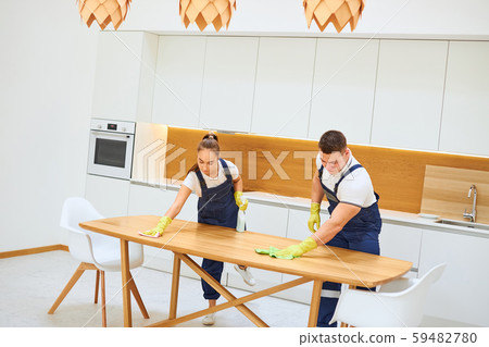 Housekeeping team cleaning kitchen table Housekeeping team cleaning kitchen table 59482780