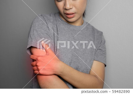 Woman suffering from pain in arm. 59482890